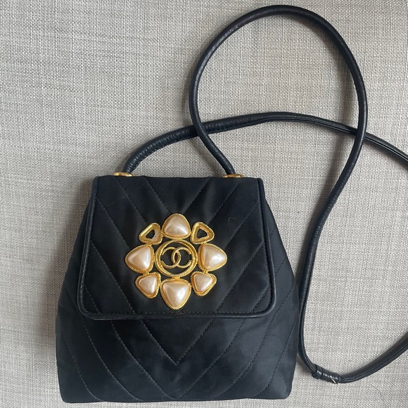 CHANEL Handbags - CHANEL Black Quilted Crossbody Bag with Pearl Flower Medallion